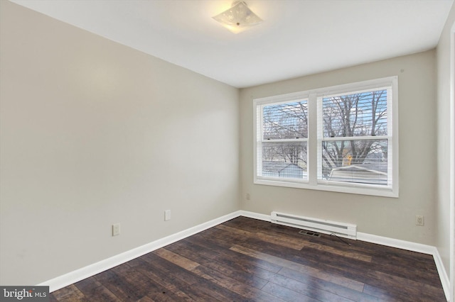 empty room featuring baseboards, a baseboard heating unit, and dark wood-type flooring