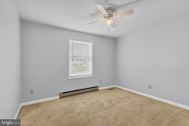 carpeted empty room featuring visible vents, baseboard heating, a ceiling fan, and baseboards