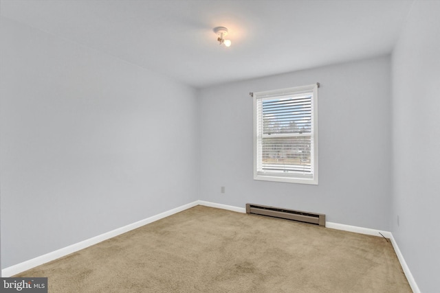 carpeted empty room featuring baseboards and baseboard heating