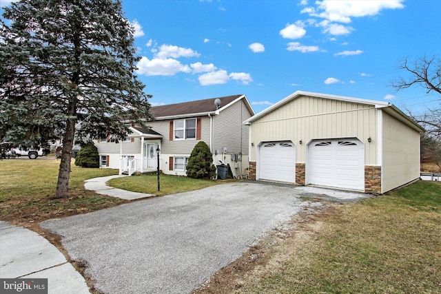 view of front facade featuring an outbuilding, stone siding, a detached garage, and a front lawn