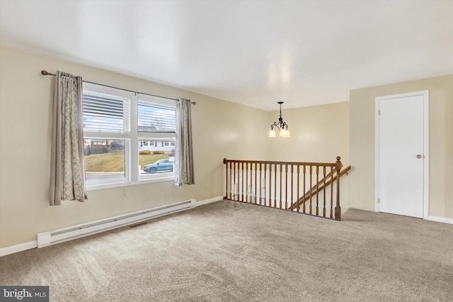 carpeted empty room with a chandelier, a baseboard radiator, and baseboards