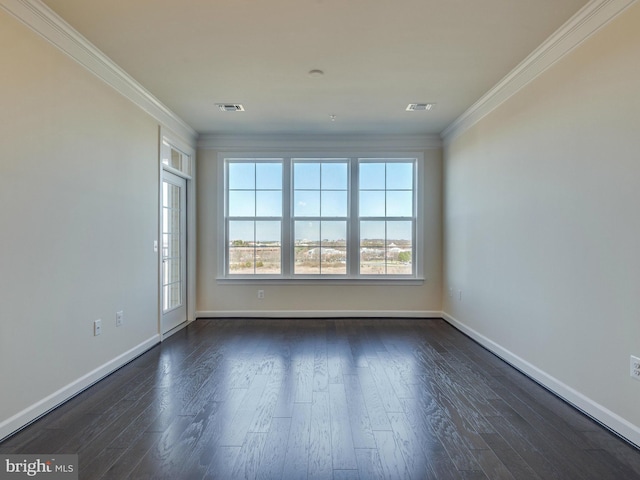 spare room with visible vents, dark wood finished floors, and crown molding