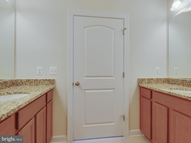 bathroom with two vanities and a sink