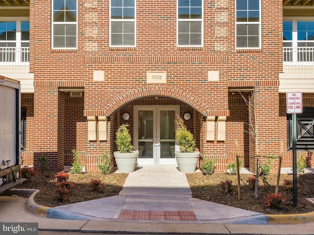 property entrance with french doors and brick siding