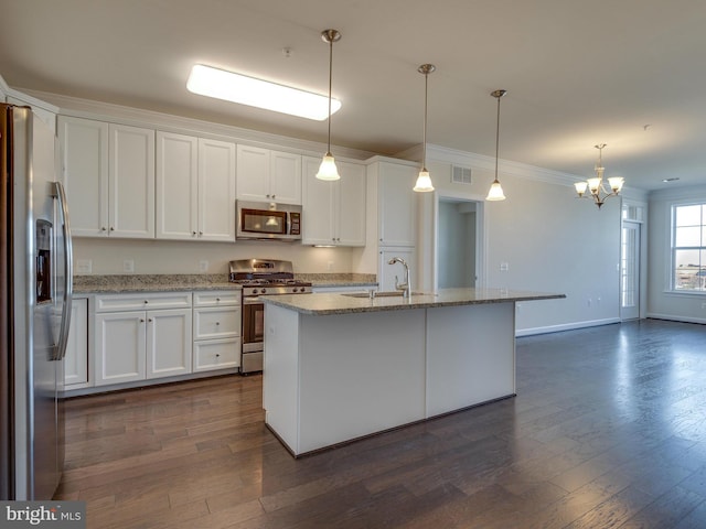 kitchen with dark wood-style flooring, stainless steel appliances, visible vents, white cabinets, and a sink