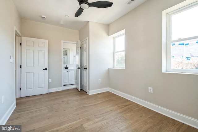 unfurnished bedroom with light wood-type flooring, visible vents, and baseboards