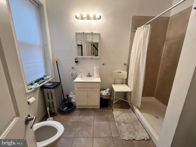 full bath featuring a shower stall, vanity, radiator heating unit, and tile patterned floors