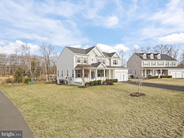 view of front of property with aphalt driveway, a garage, covered porch, and a front lawn