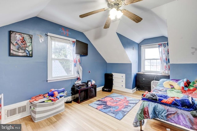 bedroom with baseboards, visible vents, lofted ceiling, ceiling fan, and wood finished floors