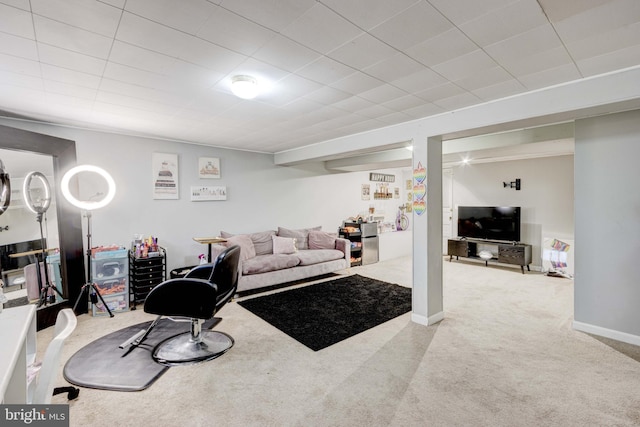 carpeted living area with baseboards