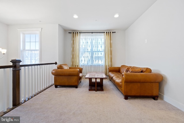 living area featuring recessed lighting, a wealth of natural light, and carpet flooring