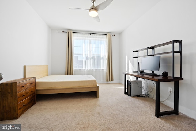 carpeted bedroom featuring a ceiling fan and baseboards