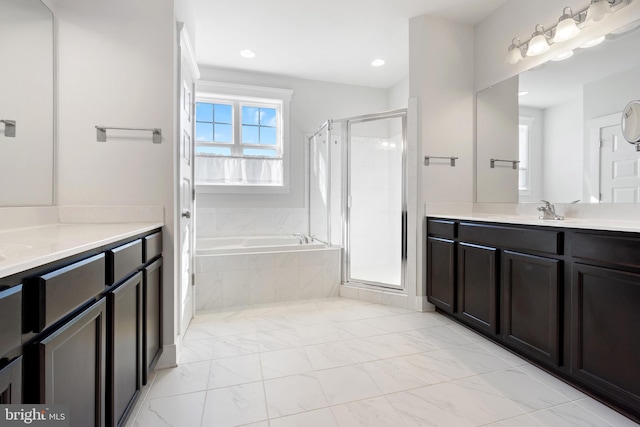 full bathroom featuring recessed lighting, a sink, two vanities, a bath, and a stall shower