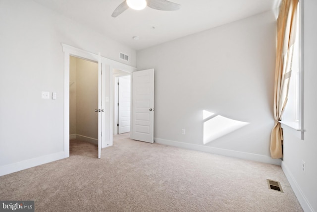 unfurnished bedroom featuring carpet floors, visible vents, and baseboards