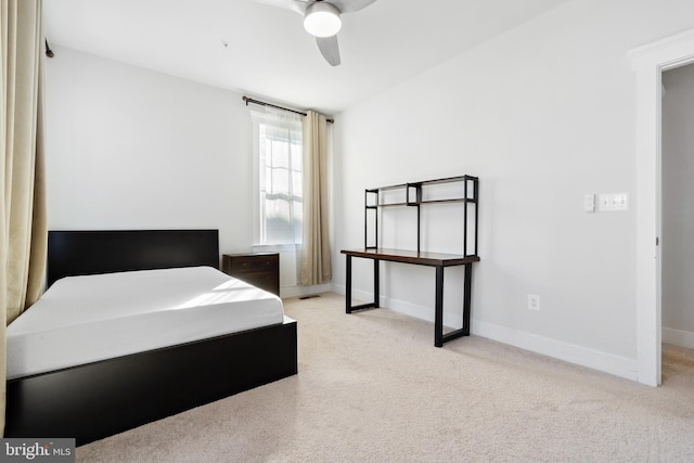 carpeted bedroom with a ceiling fan and baseboards