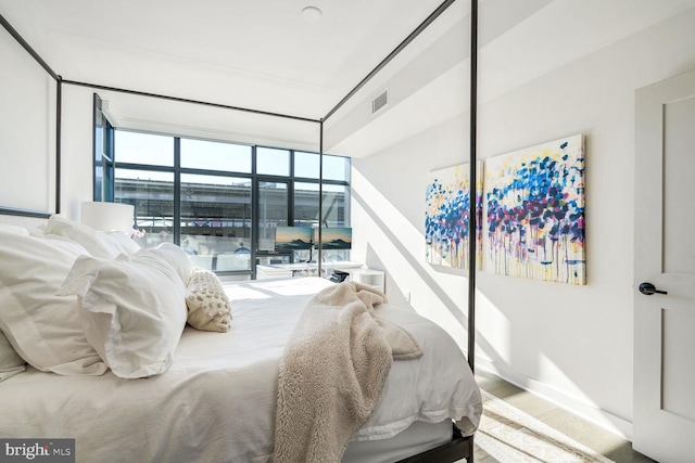 bedroom featuring baseboards and visible vents