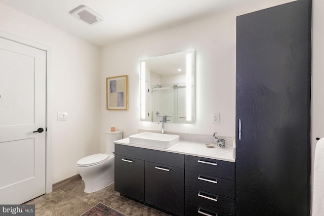 bathroom with a stall shower, visible vents, vanity, and toilet