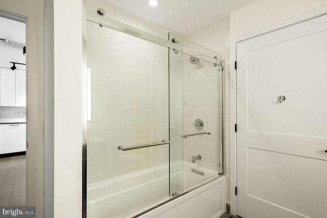 bathroom featuring bath / shower combo with glass door