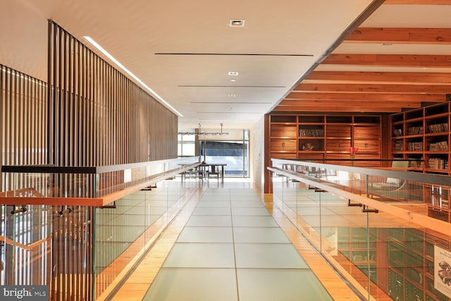 corridor featuring built in features and tile patterned flooring