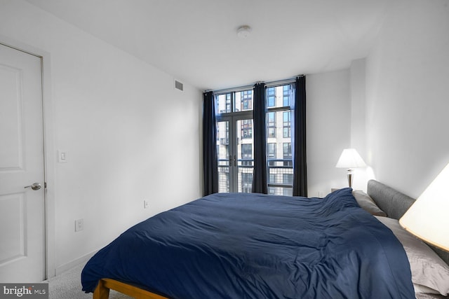 bedroom featuring carpet flooring, visible vents, and baseboards