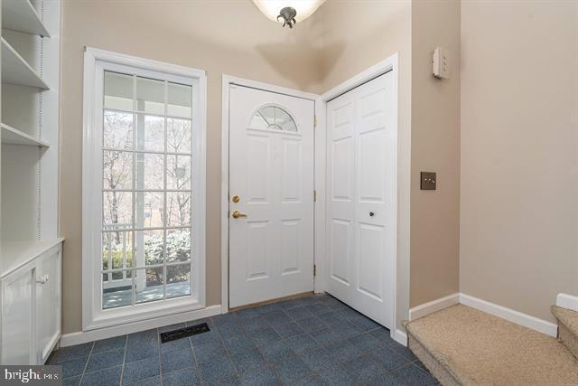 entryway with a wealth of natural light, visible vents, and baseboards