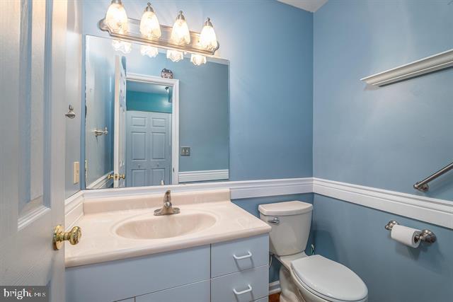 bathroom featuring vanity and toilet