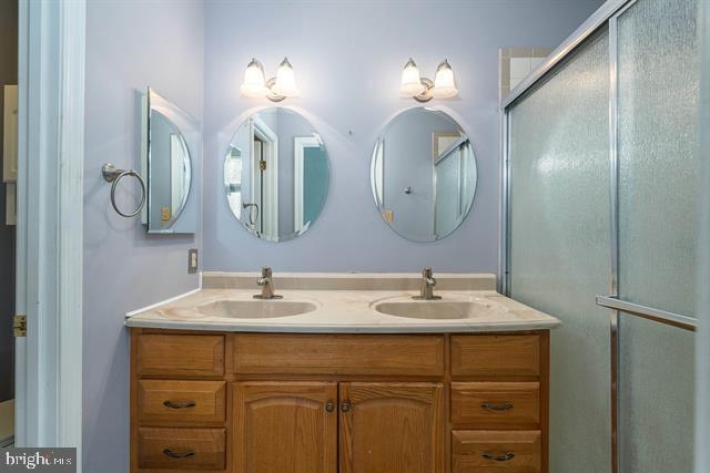 full bath featuring double vanity and a sink