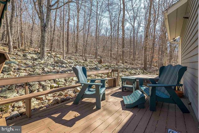 wooden deck with a forest view