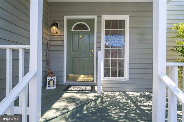 view of exterior entry with covered porch