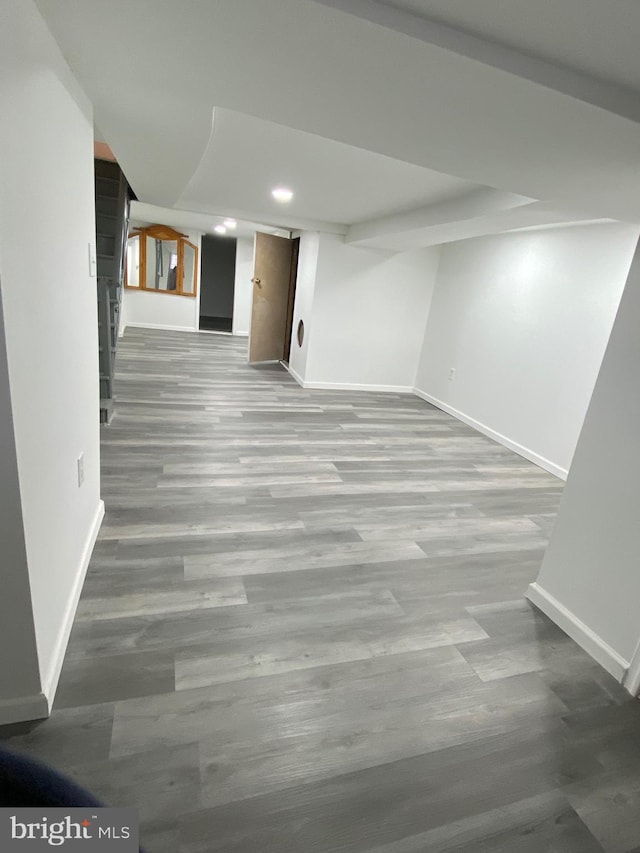 finished below grade area featuring recessed lighting, wood finished floors, and baseboards