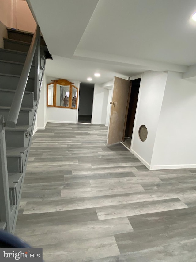 interior space featuring recessed lighting, stairway, baseboards, and wood finished floors