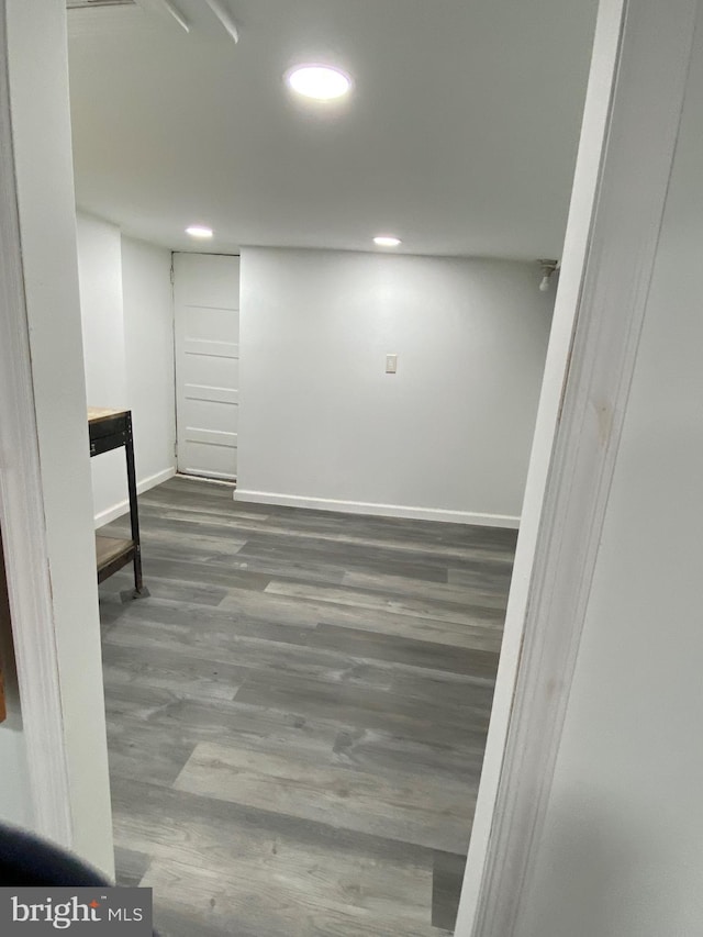 finished basement featuring recessed lighting, wood finished floors, and baseboards