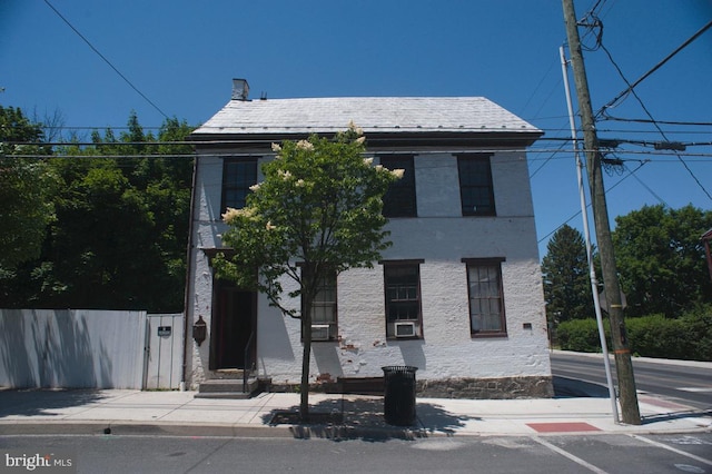 view of front of house featuring a high end roof and fence