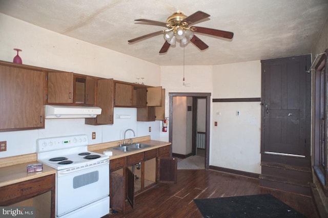 kitchen with dark wood-style floors, light countertops, white electric range, a sink, and exhaust hood