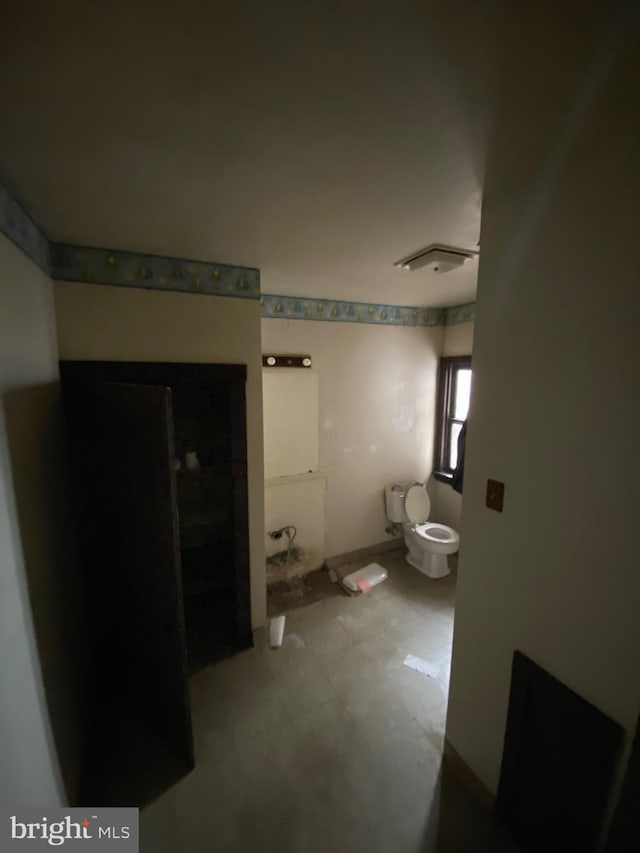 bathroom featuring toilet and tile patterned floors