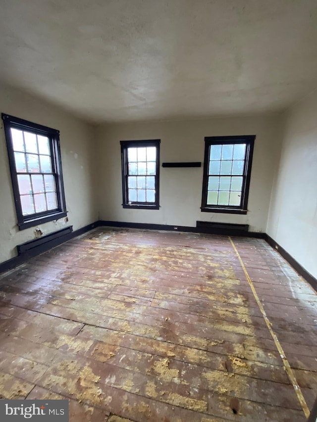 spare room featuring baseboard heating and baseboards