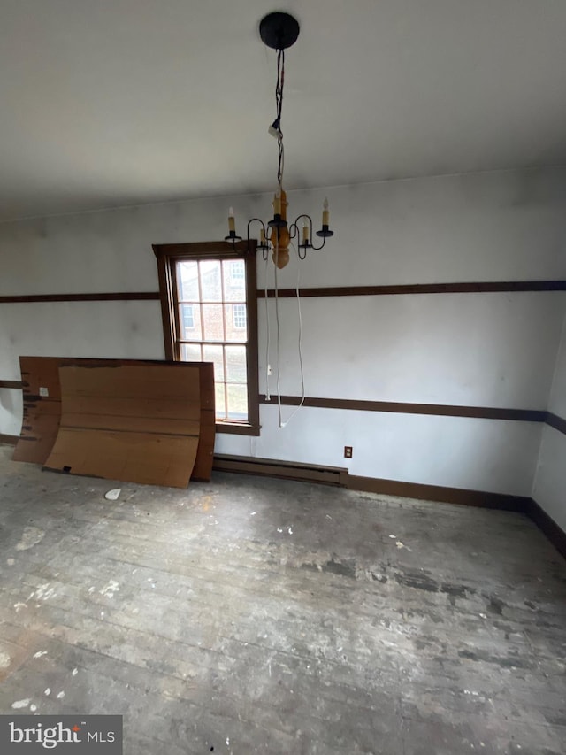 unfurnished dining area with a baseboard radiator, baseboards, a chandelier, and concrete flooring