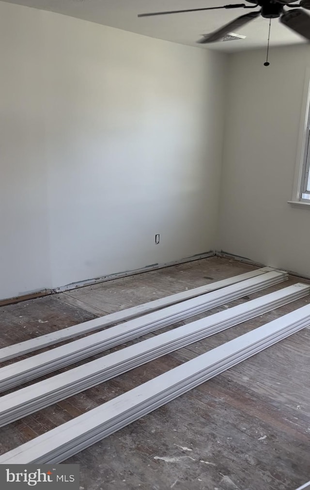 unfurnished room with a baseboard radiator and ceiling fan