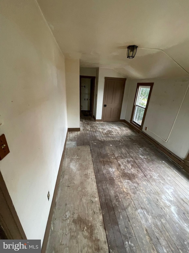 interior space featuring baseboards and hardwood / wood-style flooring