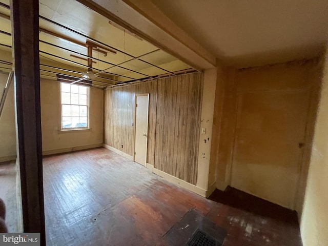 below grade area featuring wooden walls and baseboards