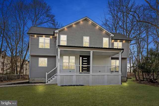 back of property featuring a porch, a yard, and a shingled roof