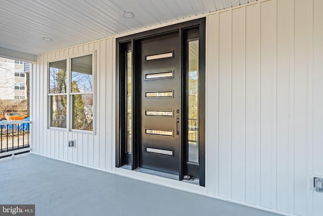 view of exterior entry featuring a porch