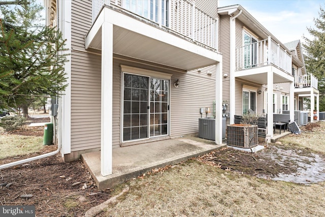 exterior space with a patio area, a balcony, and central AC unit