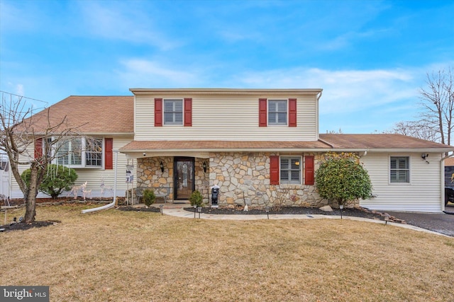 view of front of home featuring stone siding and a front yard