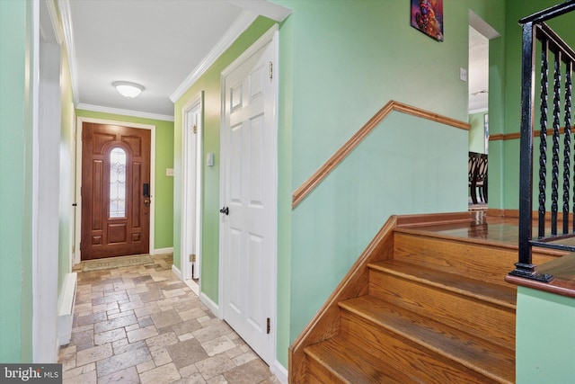 foyer with stairs, ornamental molding, baseboards, and stone tile floors