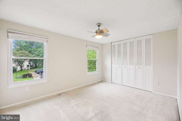 unfurnished bedroom with baseboards, a closet, carpet, and ceiling fan