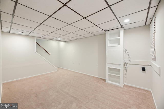 finished basement with carpet, a drop ceiling, baseboards, and recessed lighting