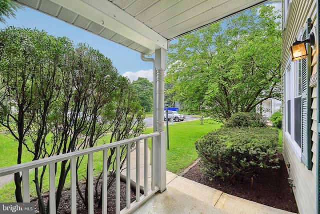 view of patio / terrace featuring a porch and view of scattered trees