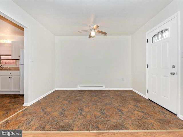 entryway with stone finish floor, baseboards, a baseboard heating unit, and a ceiling fan