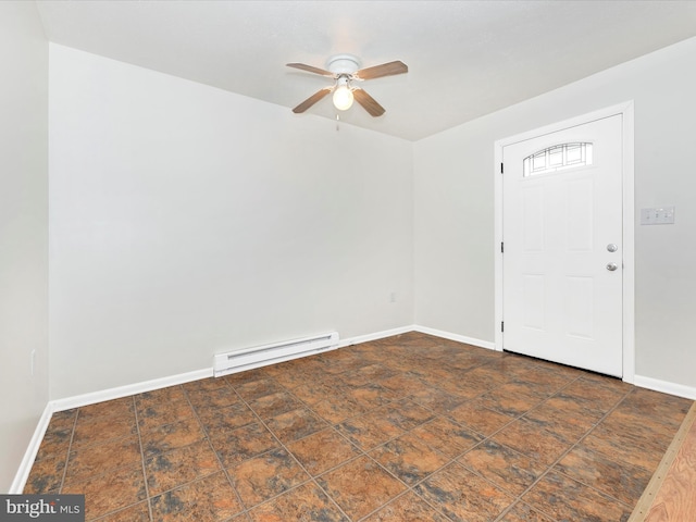 interior space with ceiling fan, stone finish flooring, baseboard heating, and baseboards